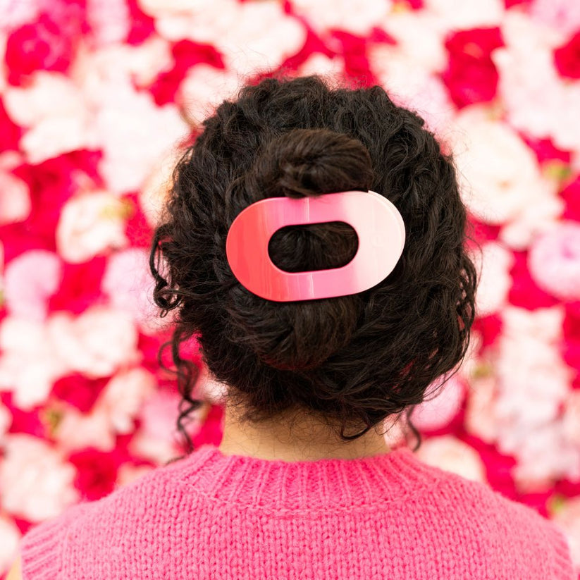 Kiss and Tell Teleties hair clip securing a bun; available in small, medium, and large sizes.
