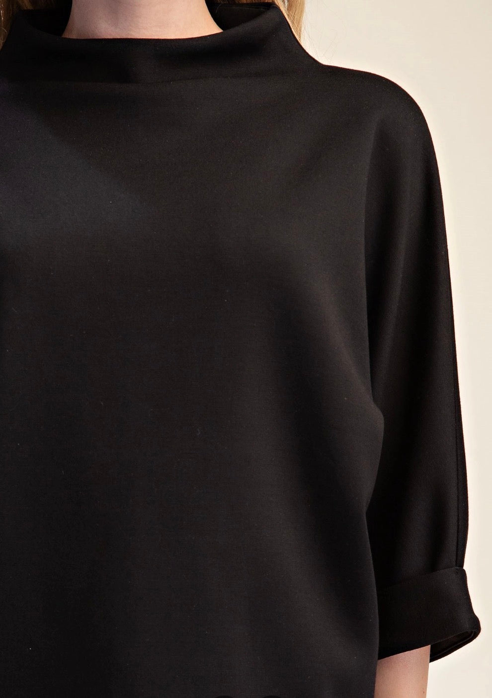 Black Everyday Mock Neck with rolled-up sleeves; available in sizes XS–XL.