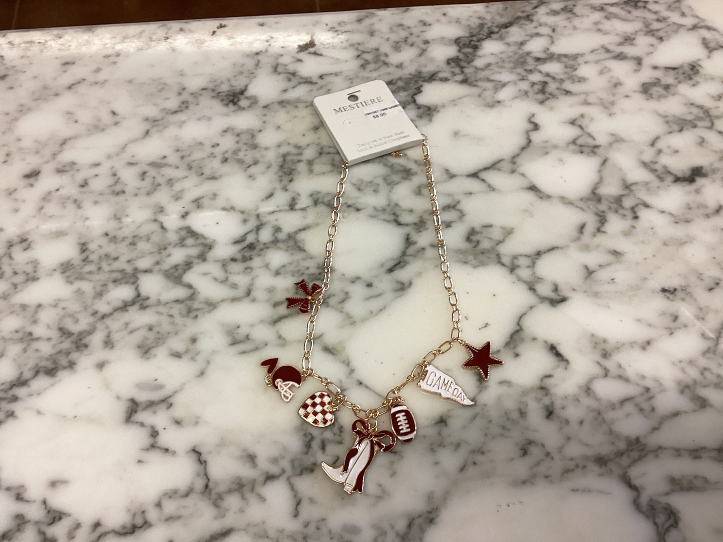 Gold Game Day Necklace featuring football, megaphone, pom-pom, star, boot charms, and an “OKLAHOMA” pendant. Available in multiple sizes.