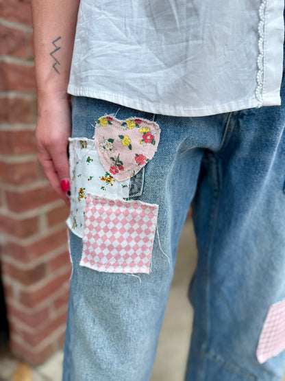 MINERAL WASHED PATCHWORK JEANS: VINTAGE WASH, floral & pink checkered patches. Sizes: XS–XL.
