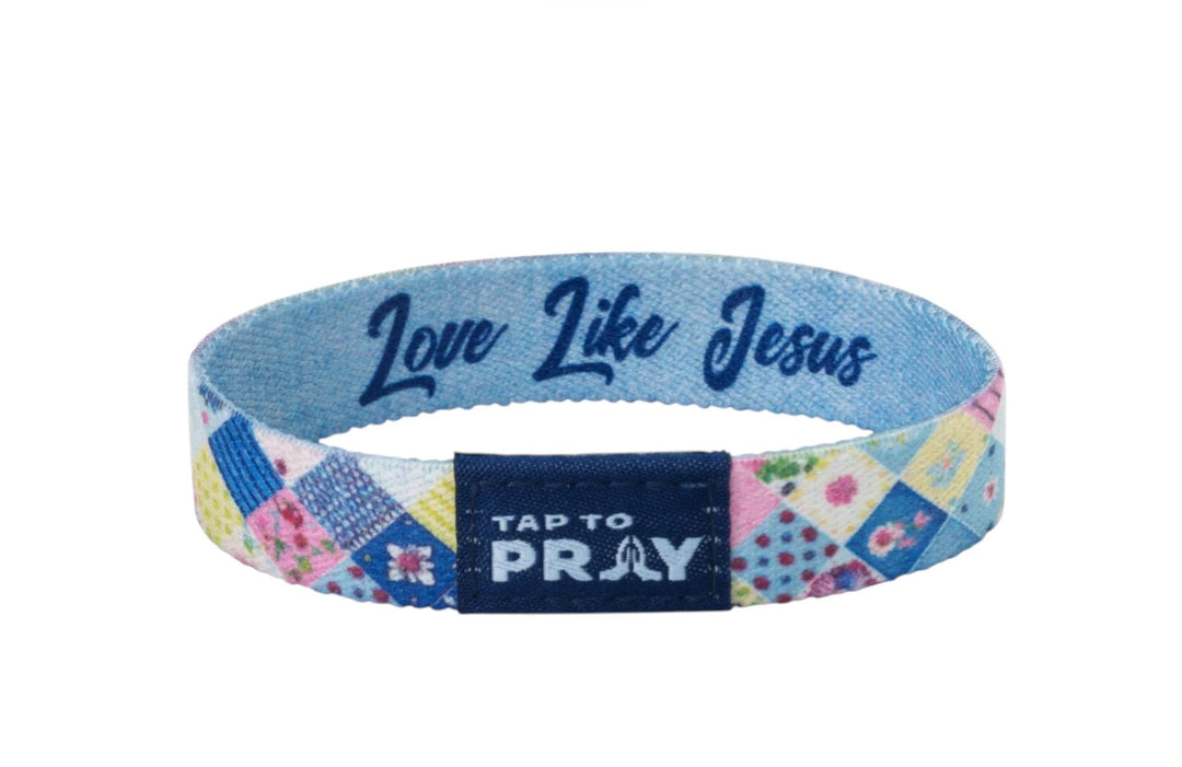 Tap To Pray™ Wristbands: multicolored patchwork elastic band with “Love Like Jesus” interior print and prayer icon tab. Sizes available.