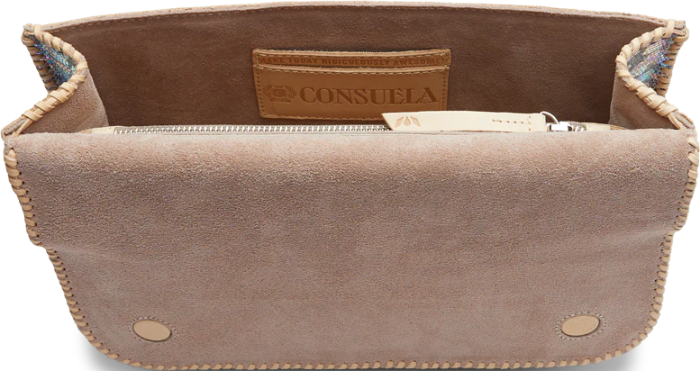 Beige suede handbag with open top, zippered compartment inside, and brown leather tag with "Consuela." Magnetic closure, rounded bottom corners, and leather trim. Available Sizes: [Sizes Not Provided].