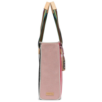Side view of the Chica Tote, Bae: rectangular pink-speckled handbag with rainbow-colored handles, small beige patch near bottom, and decorative zipper charm. Available in multiple sizes.
