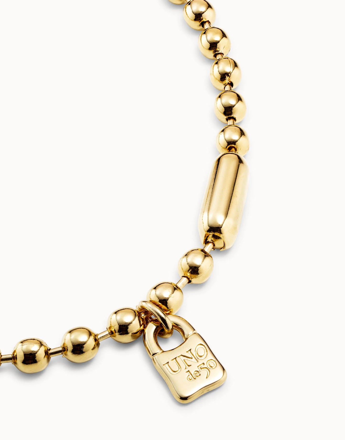 Short Beaded Necklace with Padlock: shiny round gold beads on a gold-plated chain, larger cylindrical bead near engraved padlock-shaped pendant. Available sizes: 15", 17".