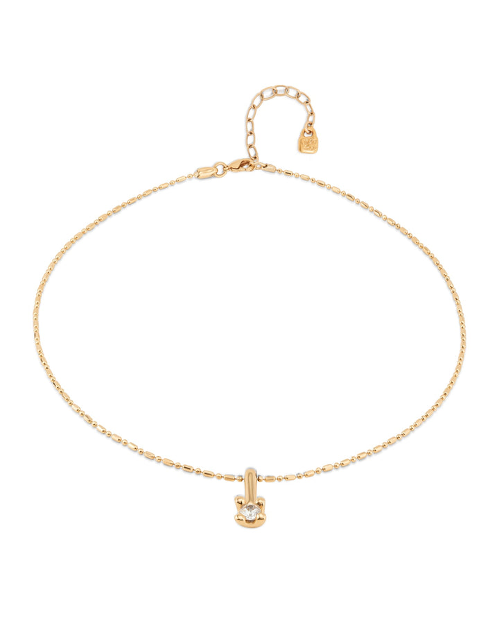 Short gold chain necklace with a white cubic zirconia pendant, adjustable clasp, extension chain, and small tag at the end. Available in 16", 18", and 20" lengths.