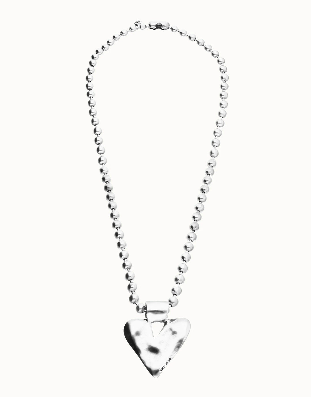 Long beaded necklace with a silver-plated, shiny heart-shaped pendant. Available in multiple sizes.