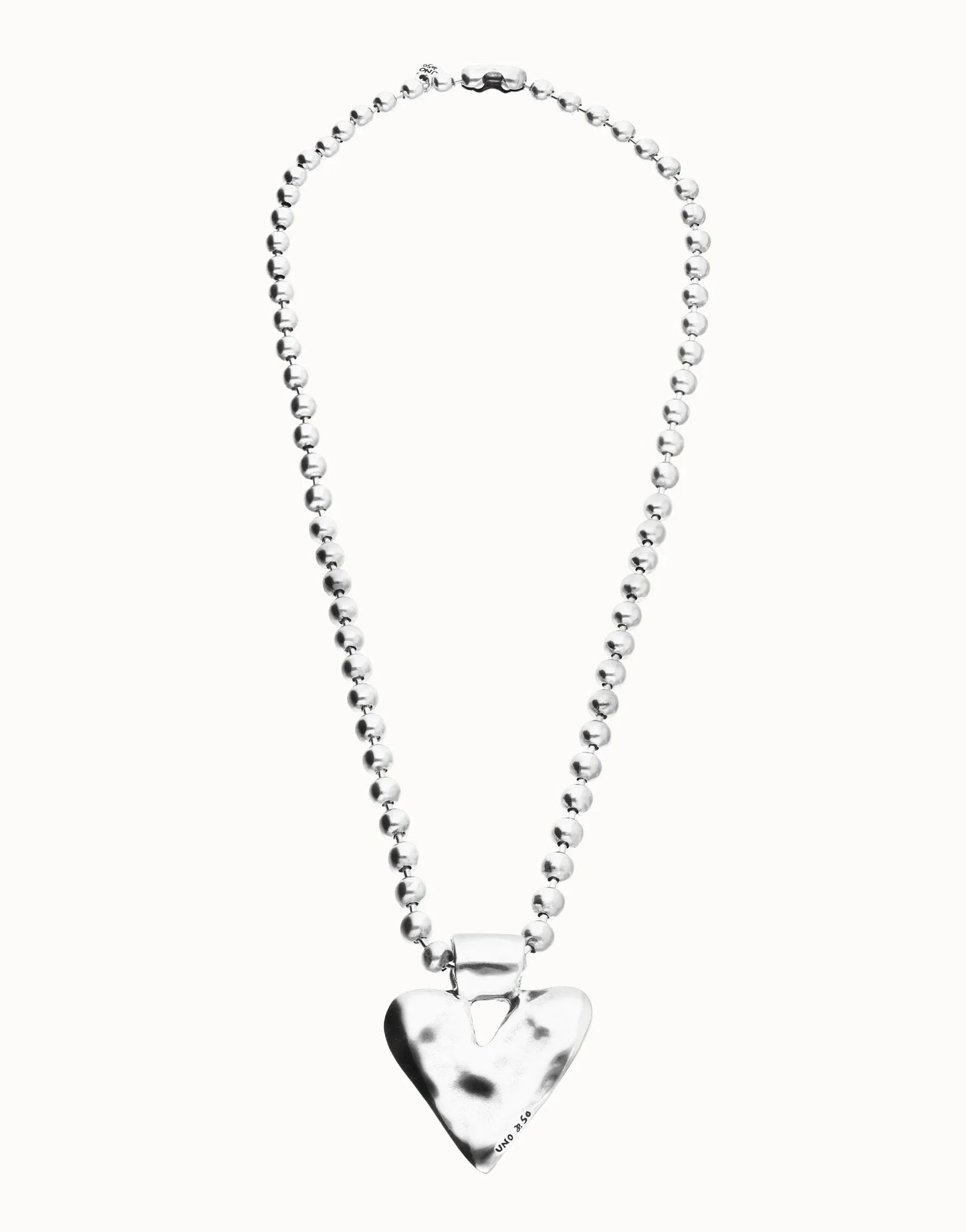 Long beaded necklace with a silver-plated, shiny heart-shaped pendant. Available in multiple sizes.