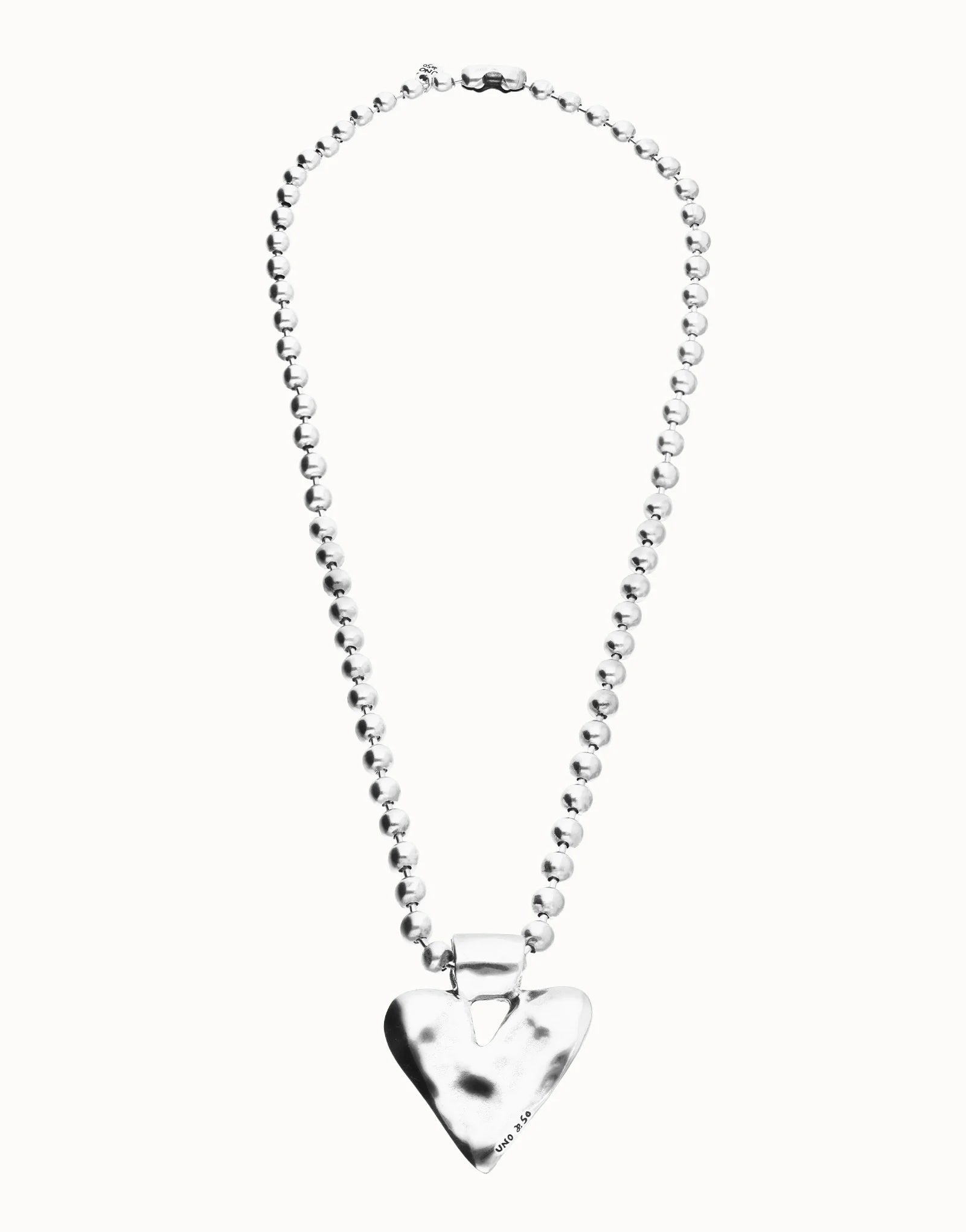 Long beaded necklace with a silver-plated, shiny heart-shaped pendant. Available in multiple sizes.