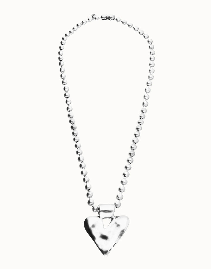 Long beaded necklace with a silver-plated, shiny heart-shaped pendant. Available in multiple sizes.