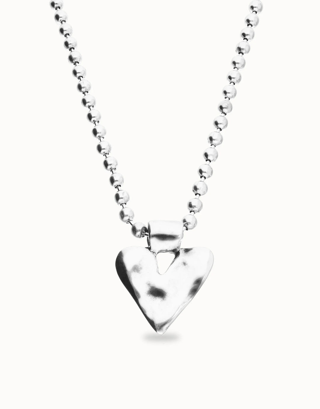 Silver-plated long necklace with beads and a hammered heart-shaped pendant. Available in multiple lengths.