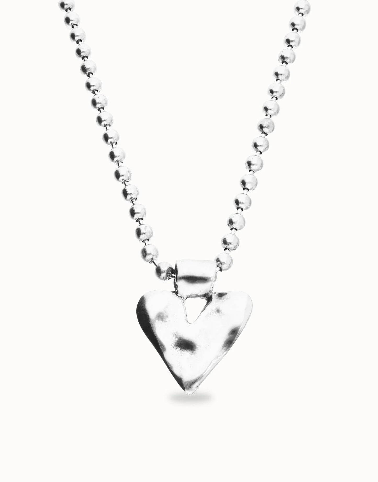 Silver-plated long necklace with beads and a hammered heart-shaped pendant. Available in multiple lengths.