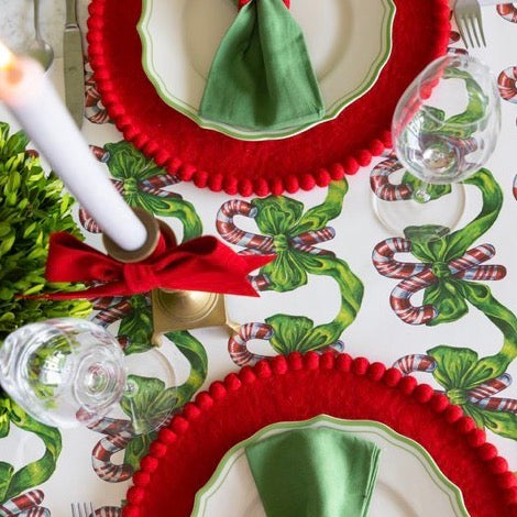 Festive Candy Canes Table Runner with a repeating pattern of candy canes and green bows.