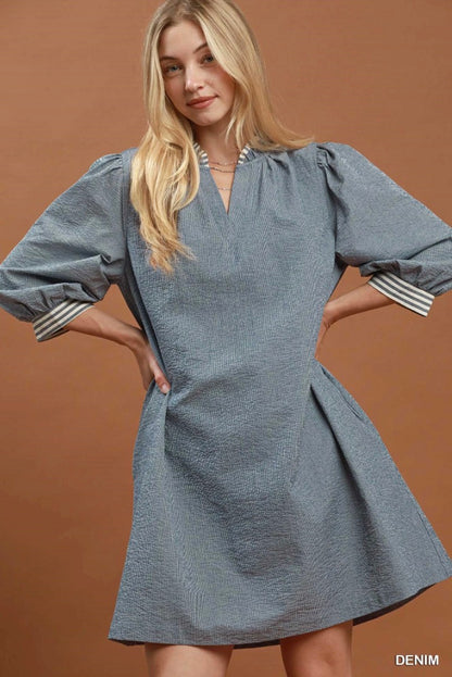 Contrast Tie Waist Mini Dress: loose-fitting, knee-length denim dress with striped contrast on puffed sleeves and cuffs. Available in sizes XS–XL.