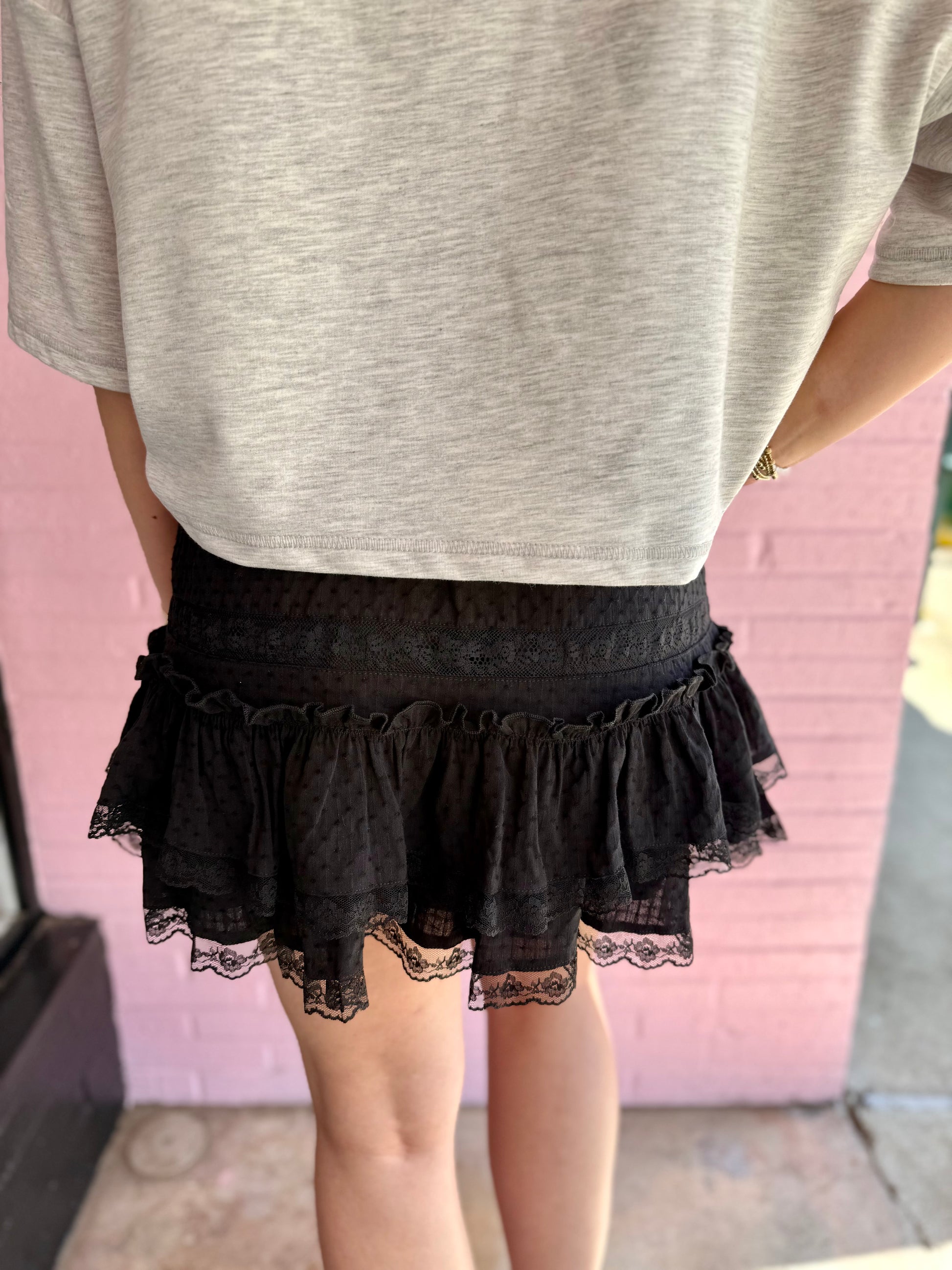 Emerson Black Lace Mini Skirt with elastic waistband and scalloped lace detailing; available in sizes XS-XL.