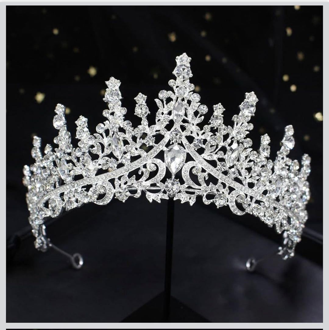 The Silver Star Tiara has sparkling silver crystals, intricate patterns, and clear gemstones. Available in S, M, and L.