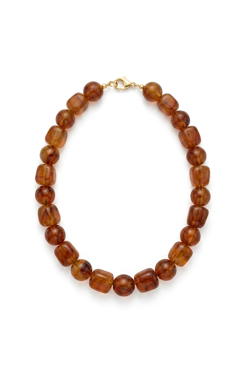 Translucent brown oblong beaded necklace with metal clasp. Available in various sizes.