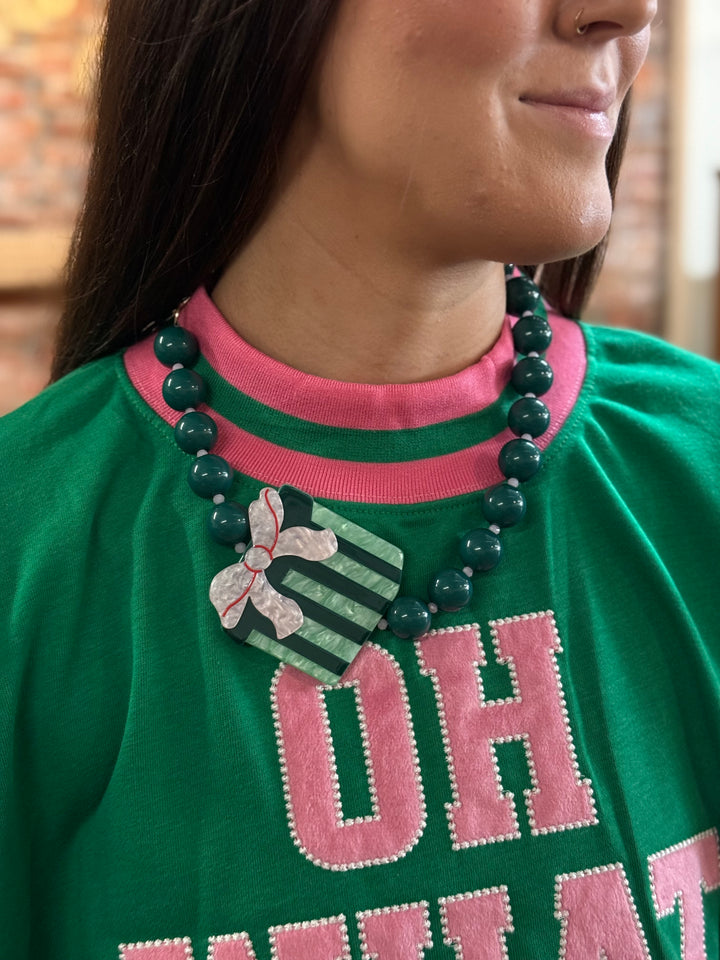 Chunky Beaded Gift Necklace with a green-striped gift box pendant and red and white bow. Available in sizes S, M, L.