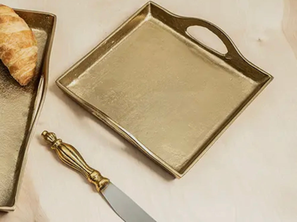 The Gilded Square Gold Tray with handle; available in small, medium, and large sizes.