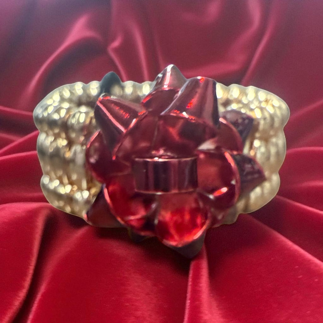 Metallic red gift bow stretch ring with metallic beads.