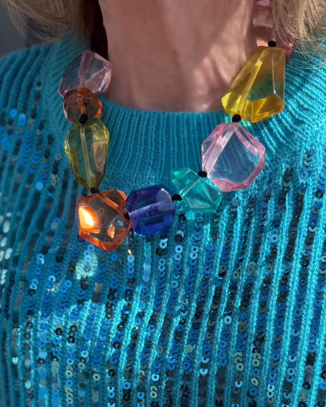 Multicolor clear stone necklace with large, faceted acrylic stones on a black cord. Sizes available.