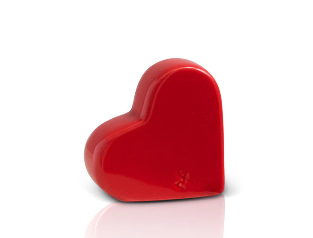 Shiny, red, heart-shaped Nora Fleming Mini with a smooth surface. Sizes available: Standard Mini.