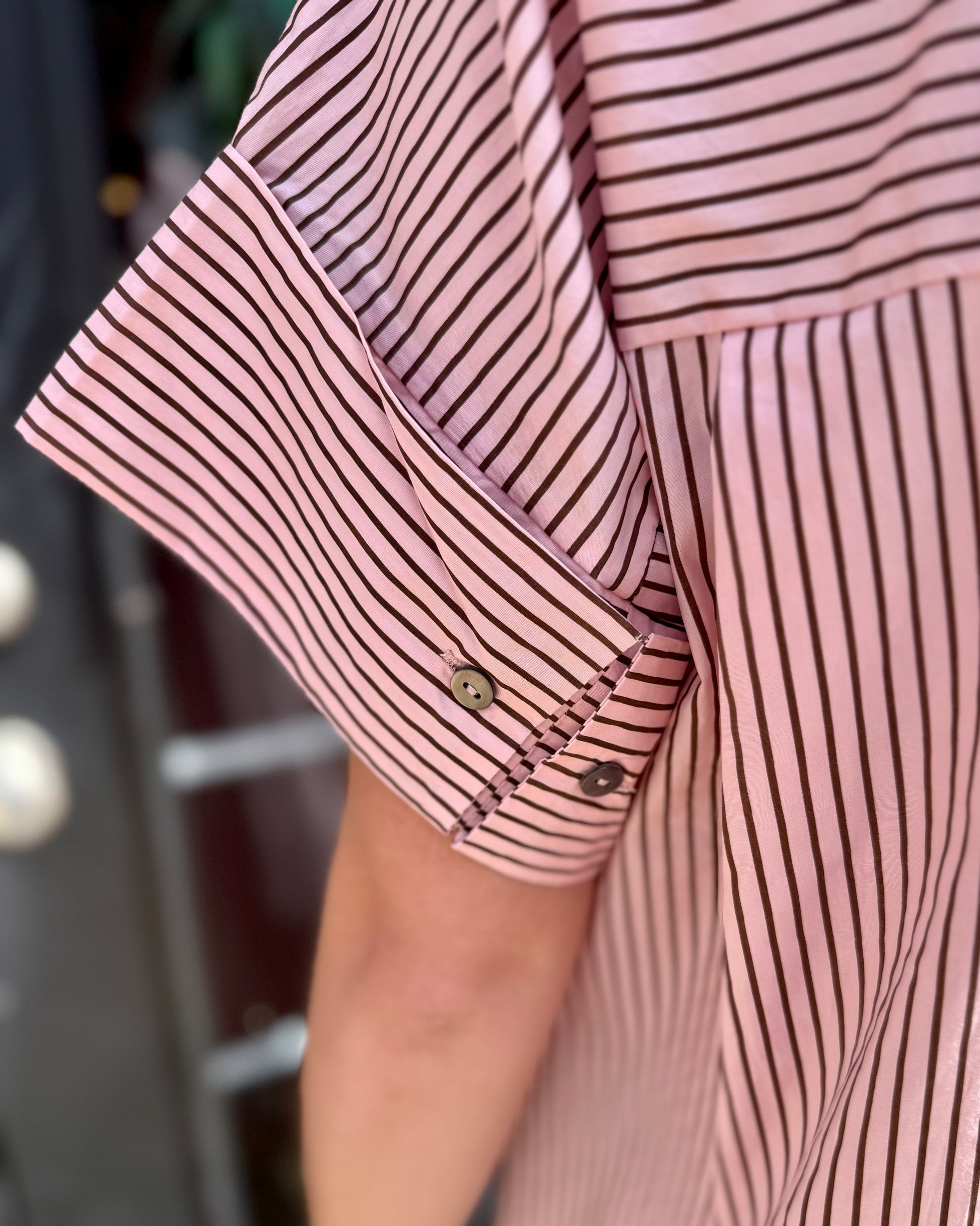 Pink & Brown Striped Polo Midi Dress with short sleeves featuring a decorative strap and two buttons. Available in sizes XS–XL.