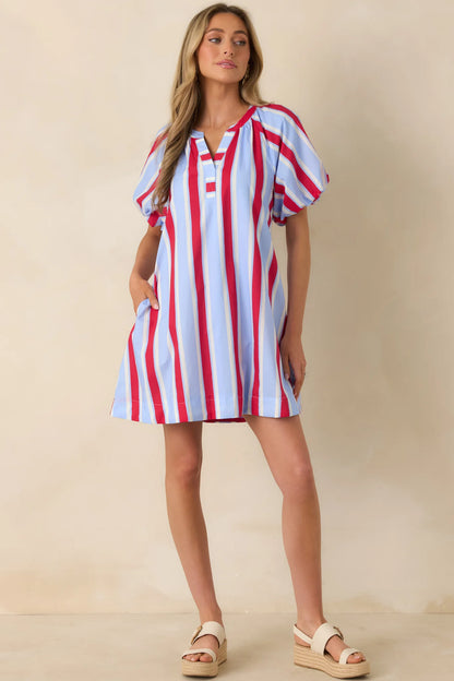 American Darling Stripe Dress with red, white, and blue vertical stripes, puff sleeves. Available in sizes XS–XL.