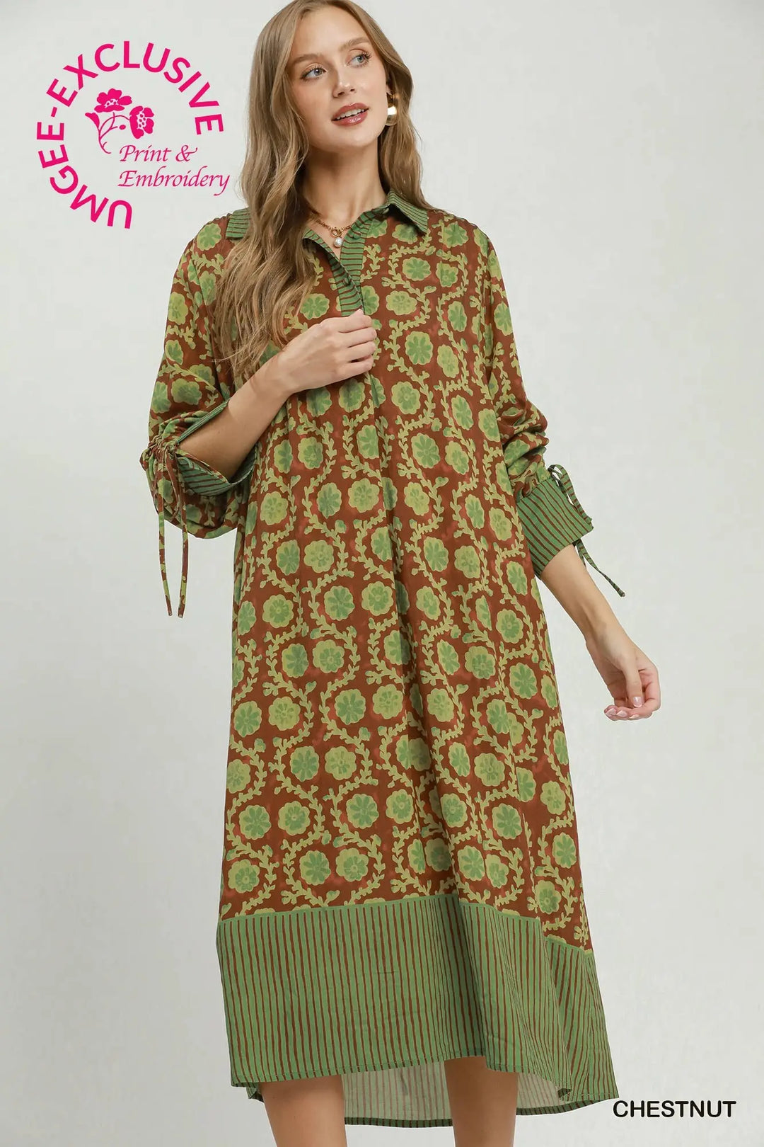 Brown and green floral midi dress with a solid green collared neckline, button placket, and striped sleeve cuffs with ties and matching hem.