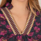 Floral Jacquard 3/4 Sleeve Dress with Contrast Collar. Dark floral dress with pink and gold flowers, decorative stitching in maroon, white, and gold on the V-neckline. Available sizes: S, M, L.