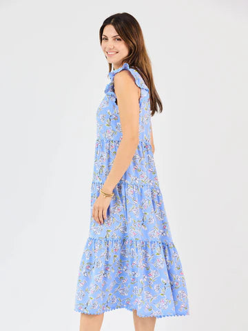 Kari Pretty Petals Dress: sleeveless blue floral tiered midi with ruffle details. Available in sizes XS–XL.
