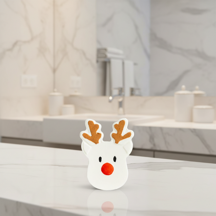 Reindeer Bath Fizzer, Sugar Plum scent, shaped like a reindeer with brown antlers and a red nose.