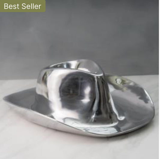 The Cowboy Hat Chip and Dip is a polished aluminum sculpture resembling a deformed cowboy hat, ideal for serving chips and dip. Available sizes: One Size.