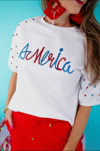 Dreaming in The Stars Tinsel Top with “America” red/blue beading, red star sleeves. Available in XS-XL.