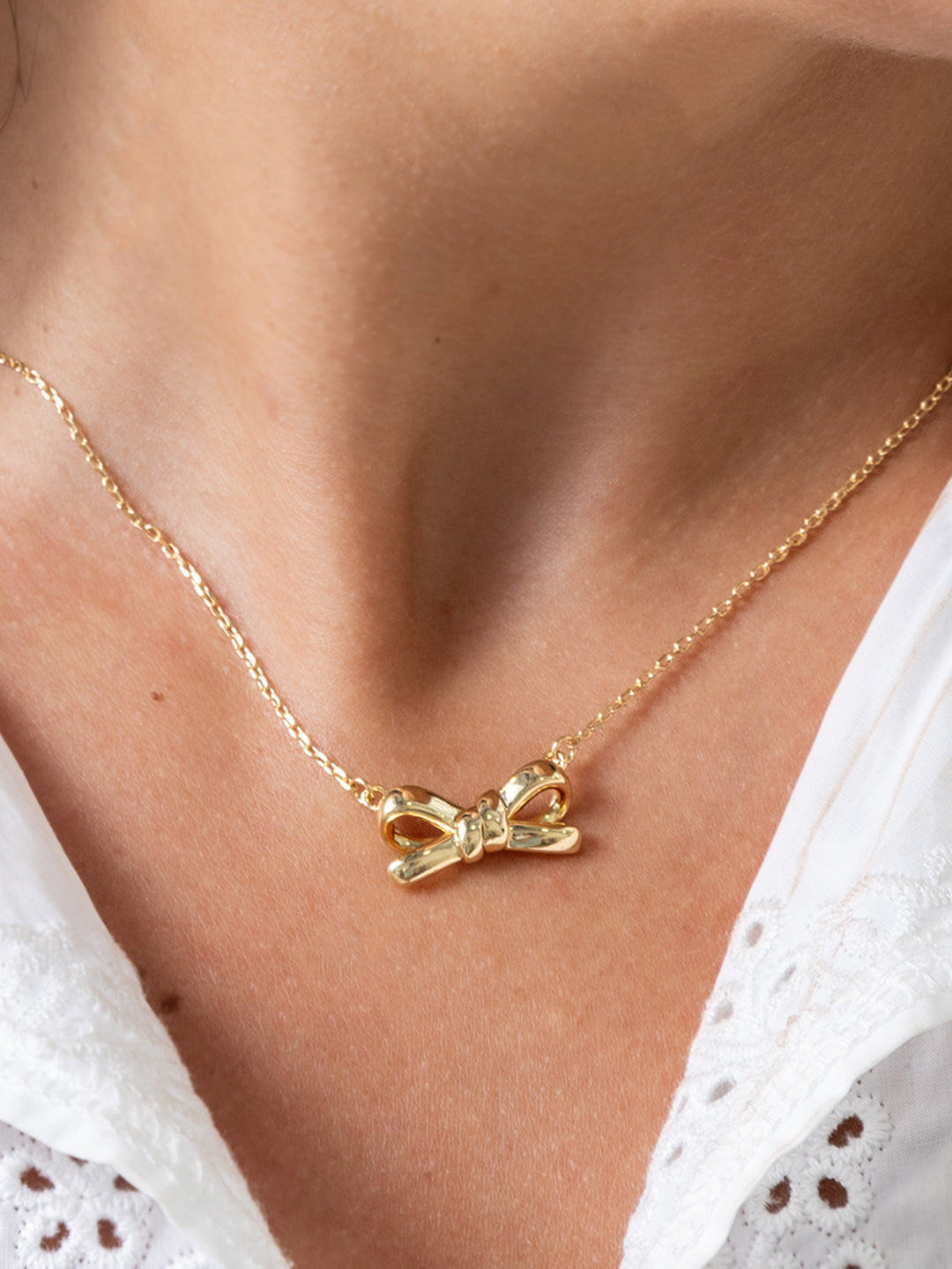 Lux Collection Gold Bow Necklace, 18k gold plated with bow pendant, available in 16", 18", and 20" lengths.