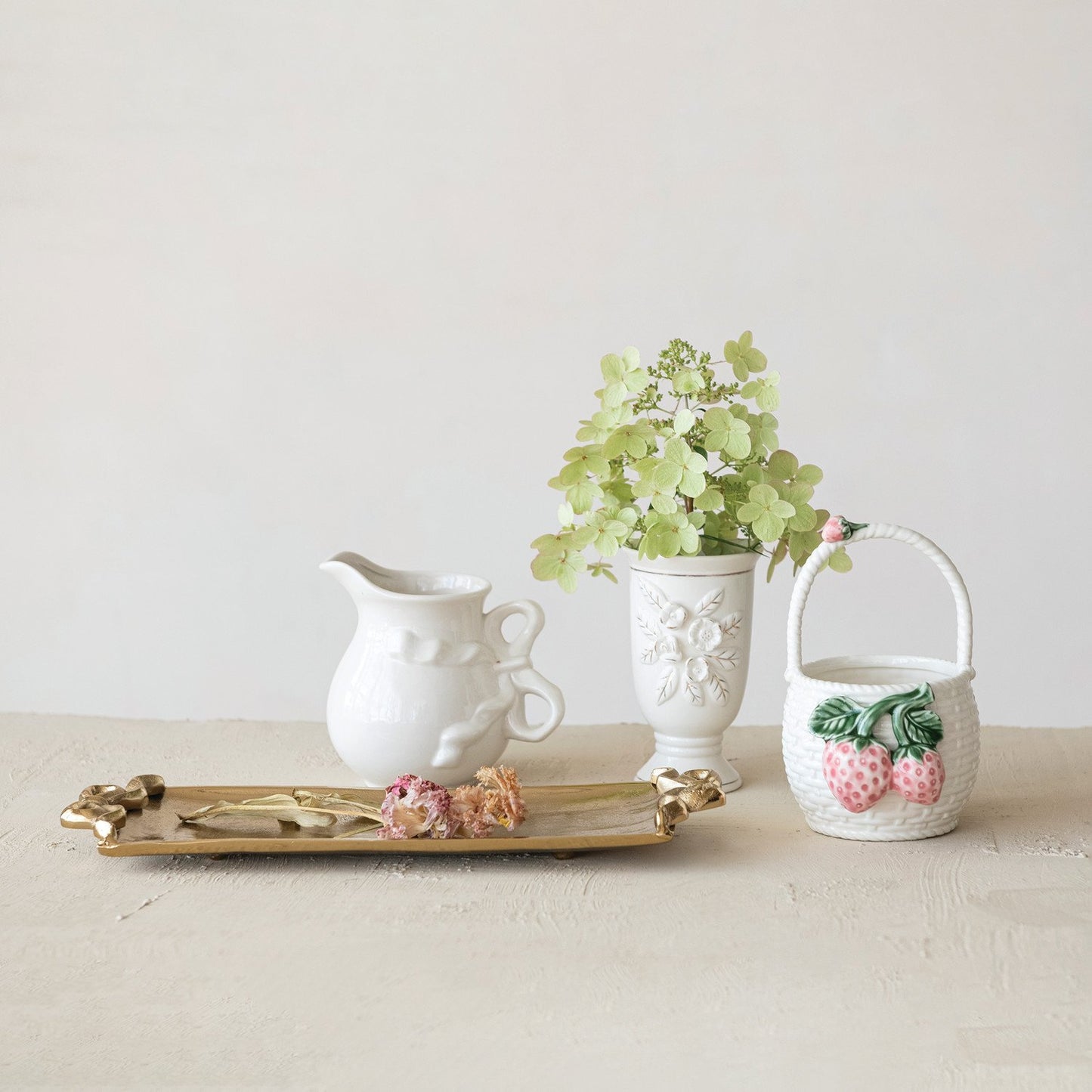 Stoneware Pitcher with Bow Handle on gold tray. Available in small, medium, and large sizes.