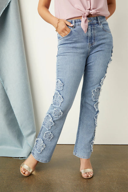 Light blue, high-waisted Everstretch Baby Bootcut Ankle Flower Jeans with large distressed patches. Available in sizes 24-32.