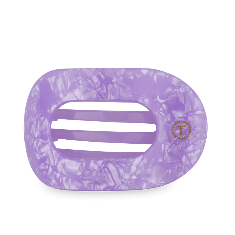 Rectangular marbled lavender hair claw with rounded edges, three wide openings, gold emblem; available in multiple sizes.