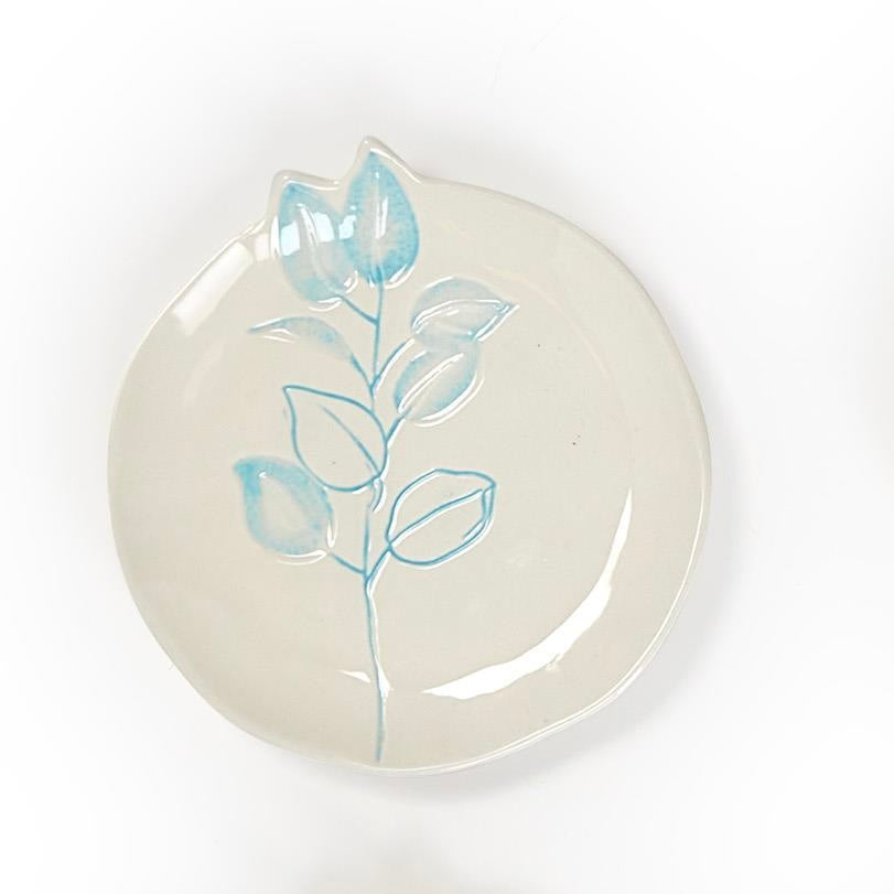 Round off-white ceramic plate with light blue floral design; available in small, medium, and large sizes.