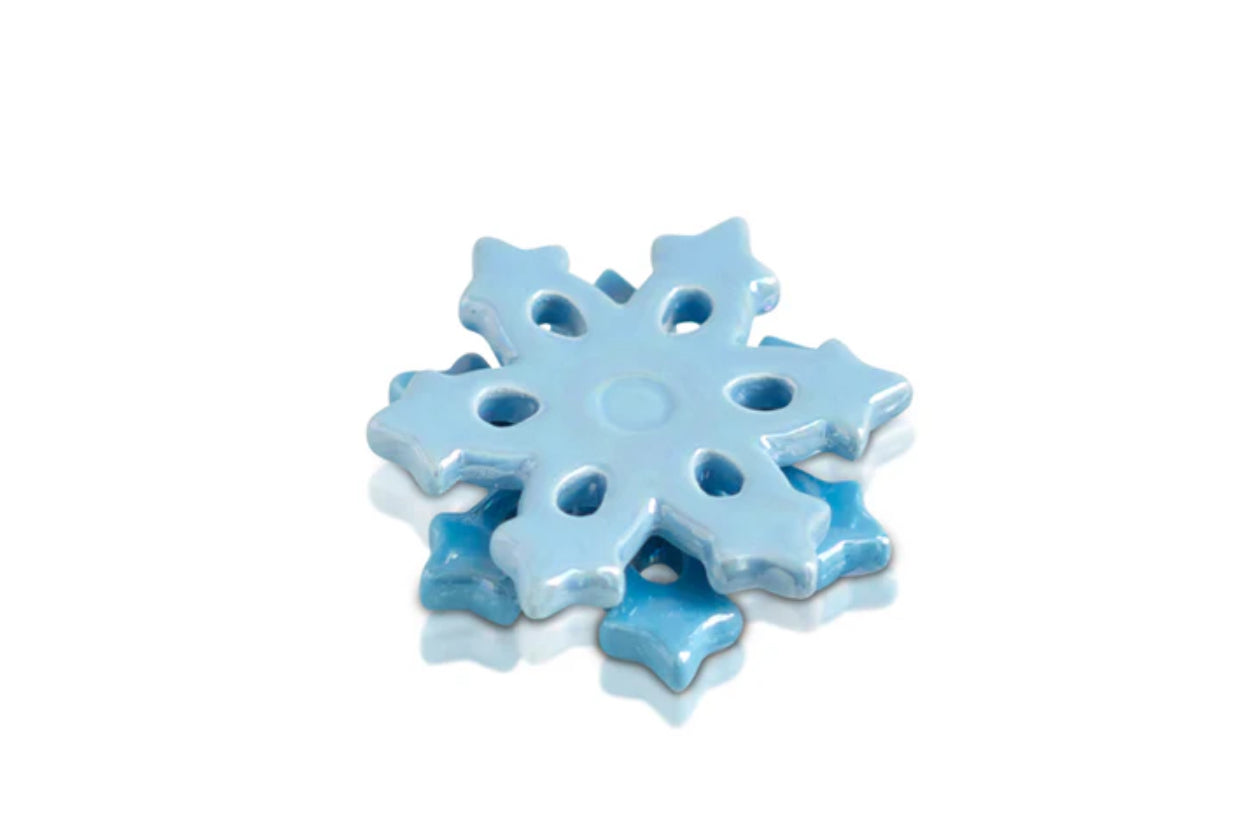 Glossy ceramic snowflake ornament in light blue with intricate cut-out patterns. Reflective surface, smooth texture, detailed design. Available sizes: one standard size.