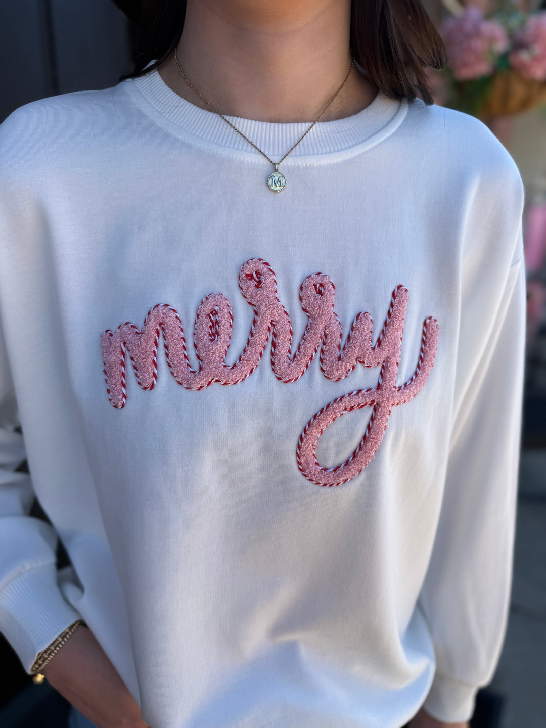 White Sarah Merry Boucle Sweatshirt with textured pink and red “merry” embroidery. Available in all sizes.