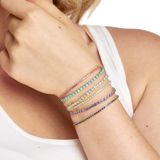 Dazzle Bracelets: adjustable rhinestone tennis bracelets in turquoise, purple, pink, and clear. Sizes: S, M, L.