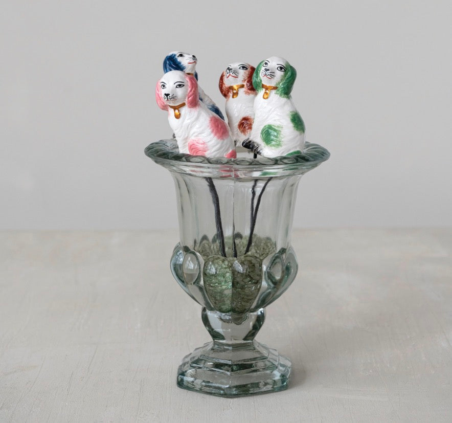 Set of four hand-painted stoneware dog plant stakes on sticks; available in small and medium sizes.