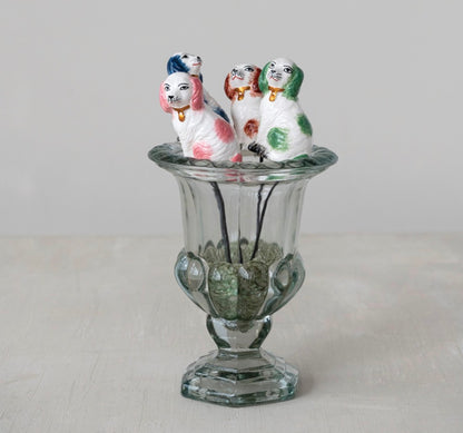 Set of four hand-painted stoneware dog plant stakes on sticks; available in small and medium sizes.