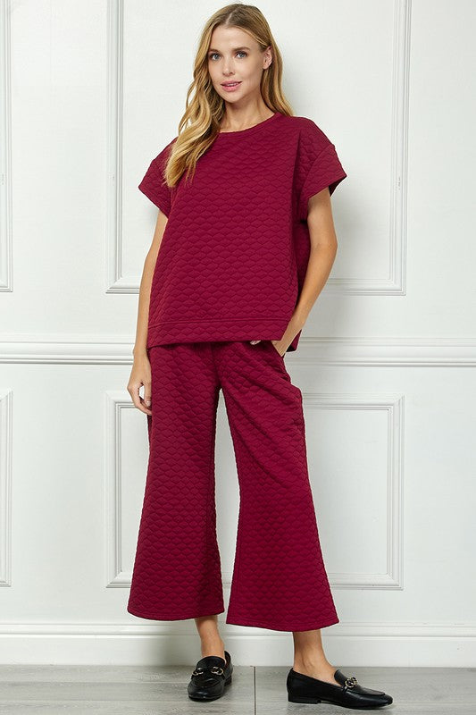 Honey Comb Textured Set in burgundy with wide-leg pants; available in sizes XS-XL.