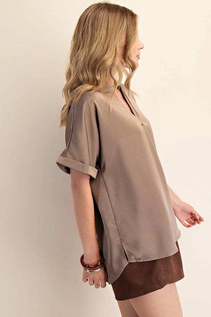 Mocha Signature Satin Top: loose taupe V-neck with short sleeves; available in sizes XS–XL.