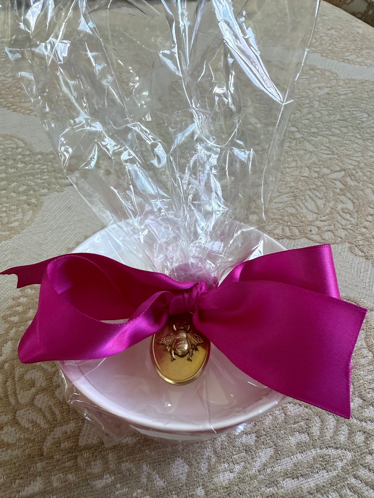 French Bee Candles white bowl in clear plastic, pink ribbon, and gold wax seal. Available in small, medium, and large sizes.