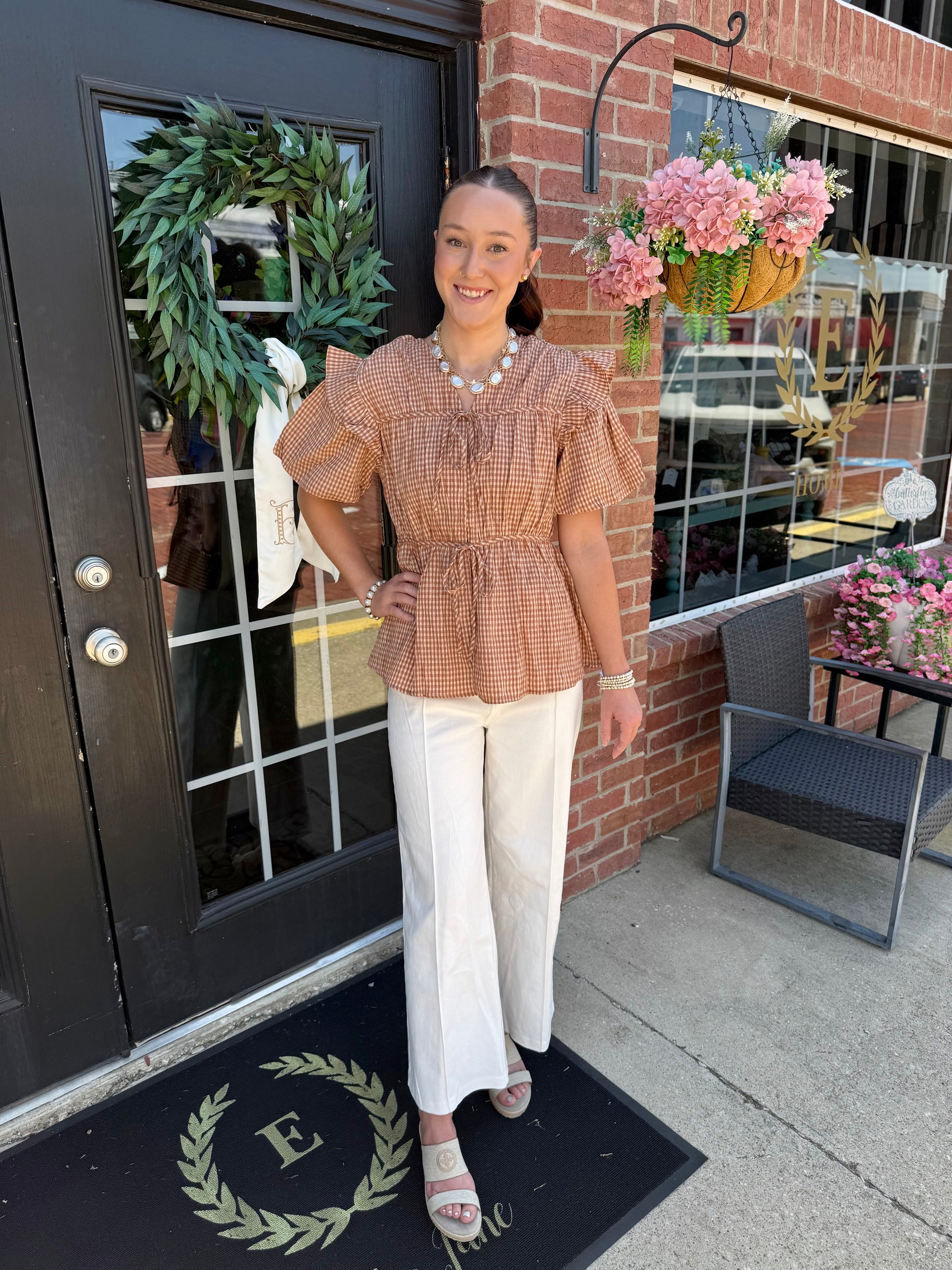 Gingham Tie Blouse in brown and cream checks with flutter sleeves, available in sizes XS–XL.