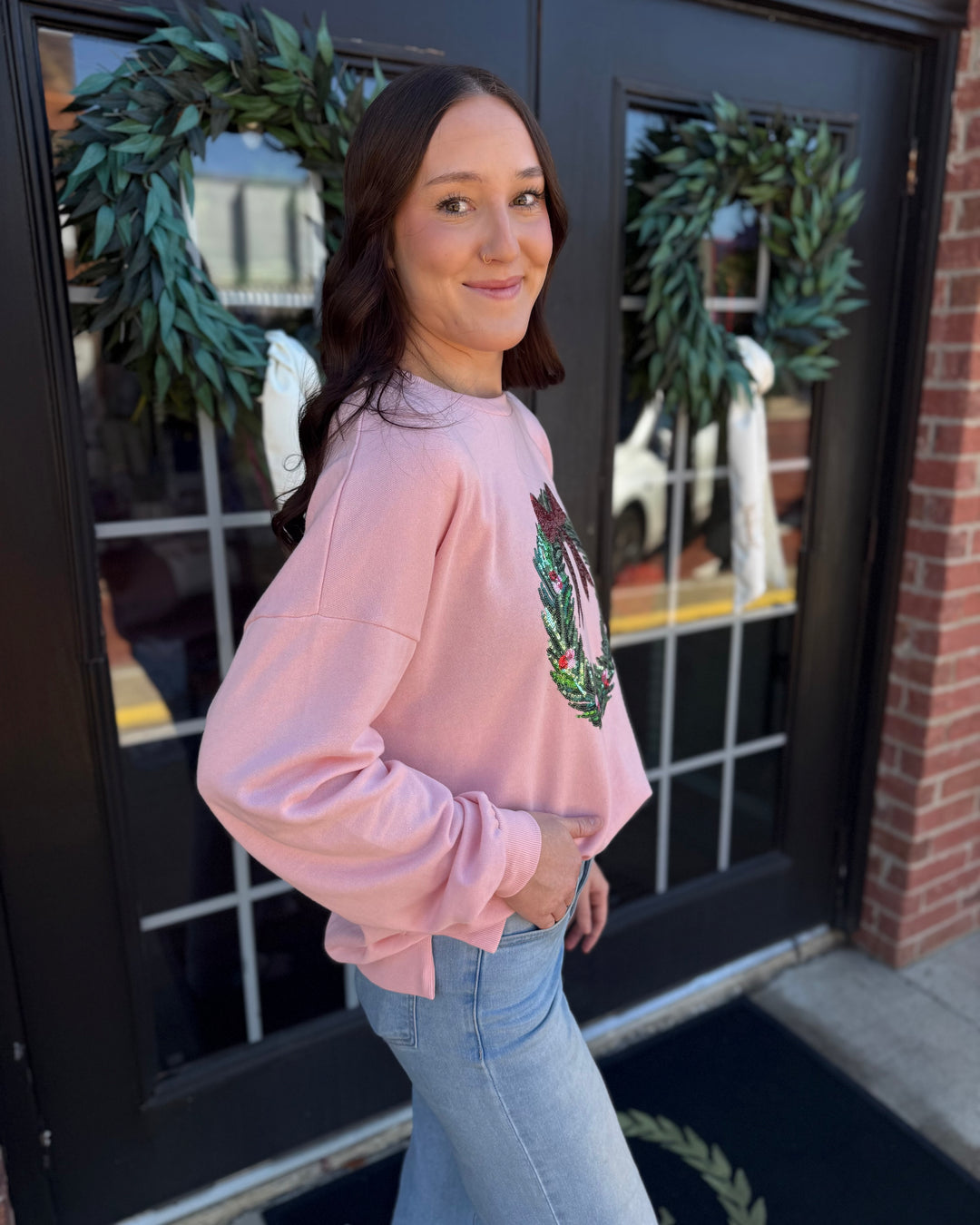Clara Wreath Sequin Sweatshirt in light pink with sequined chest wreath and side-slit hem. Available in multiple sizes.