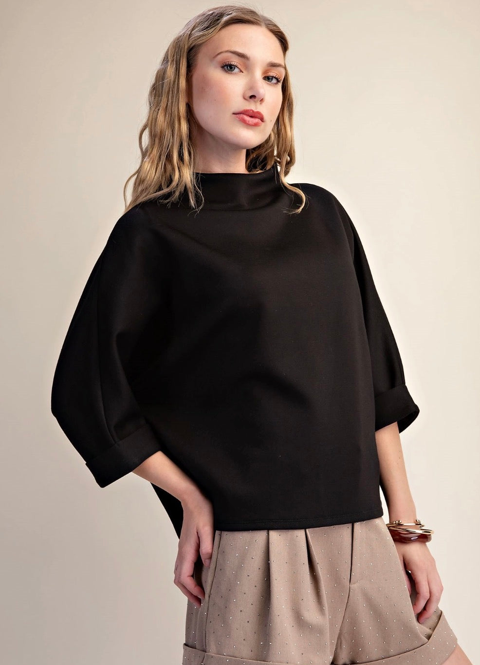Loose black 3/4 sleeve Everyday Mock Neck top, available in sizes XS-XL.