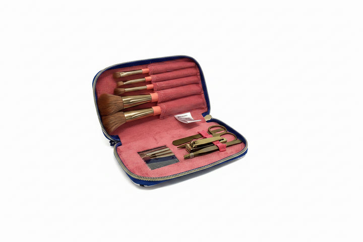 Blue gingham zippered cosmetic kit with pink interior, five brushes, scissors, tweezers, nail clippers. Sizes: small, medium.